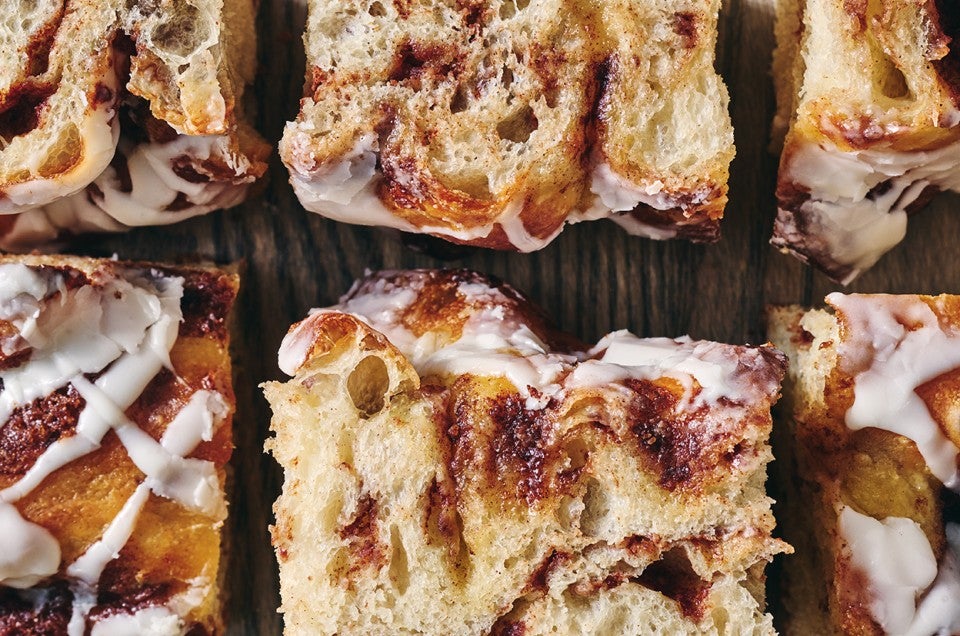 Cinnamon Roll Focaccia laid out on a cutting board - select to zoom